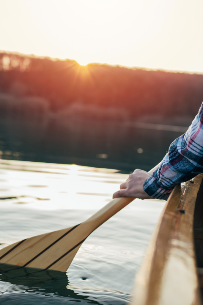 Lake life in New Brunswick Canada, canoeing on a relaxing lake in calm waters at sunset