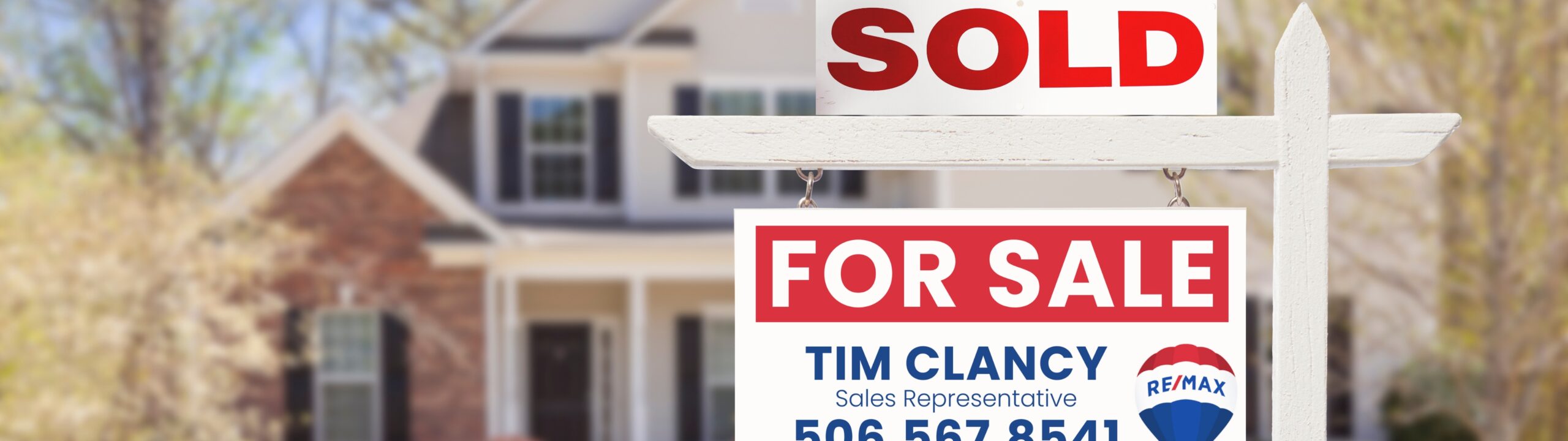 Spring home in New Brunswick with for sale sign – best time to sell a house in NB